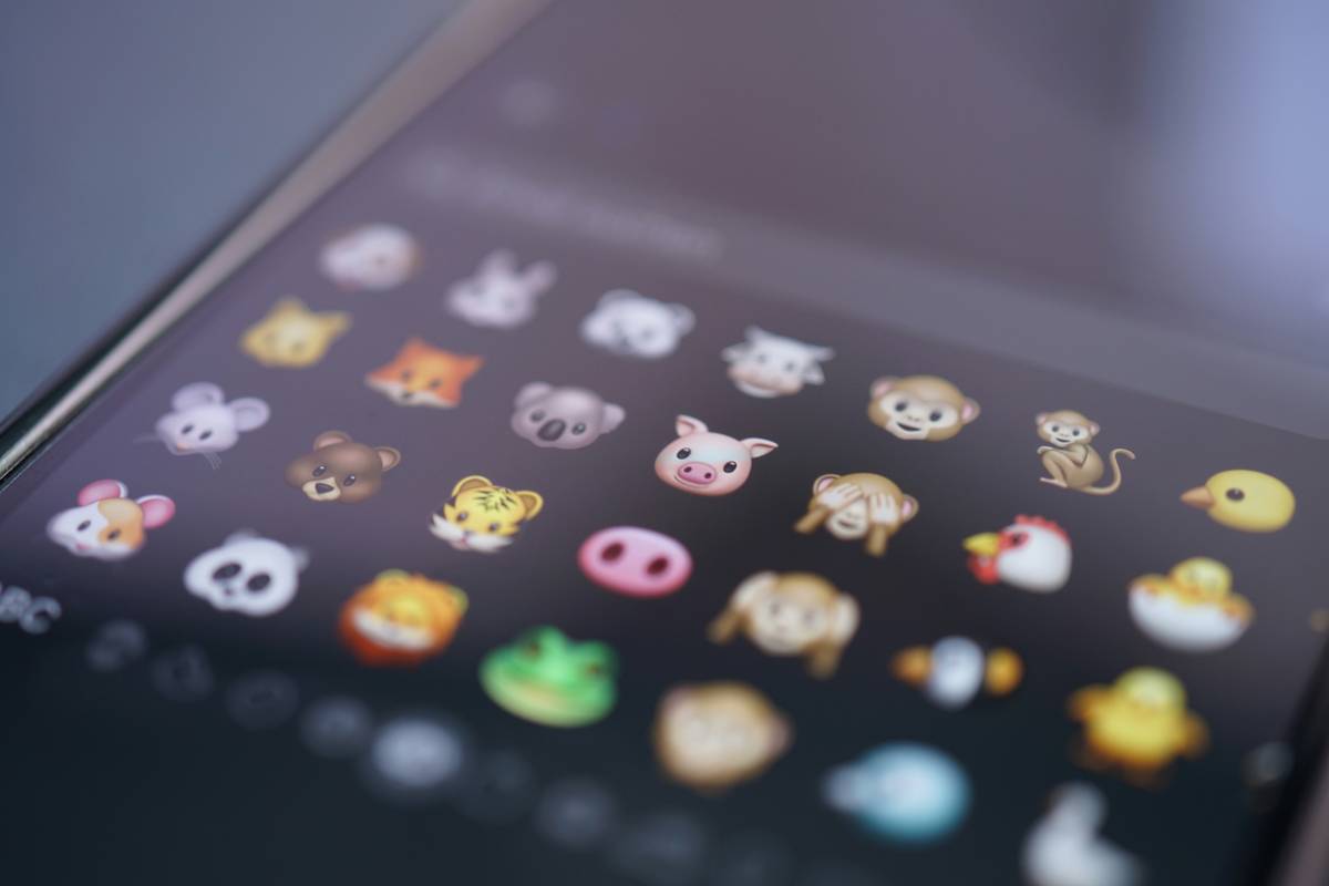 Child smiling while playing a virtual pet game for kids on a tablet